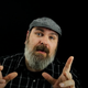 Mike Fahey of Kotaku points two fingers upward in a pitch-black room.